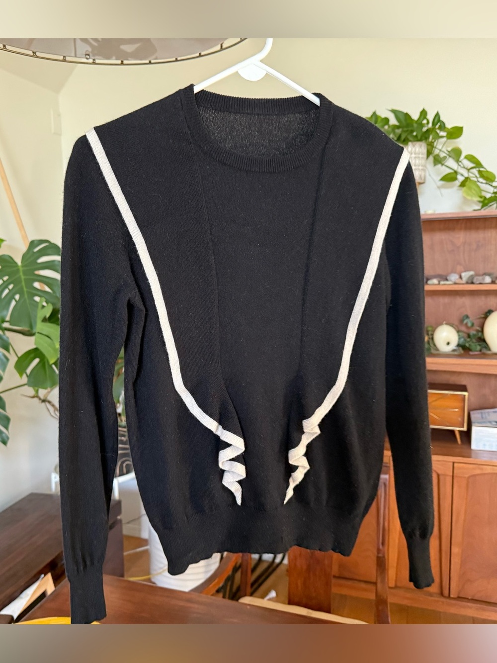 100% cashmere black sweater with ruffle details and white trim